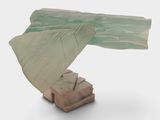 a sculpture of a bird that is sitting on a table
