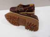 men ' s sperry boat shoes with brown soles on a white surface