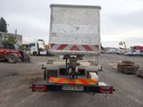 a truck that is parked in a lot with other trucks