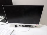 a computer monitor and keyboard on a desk