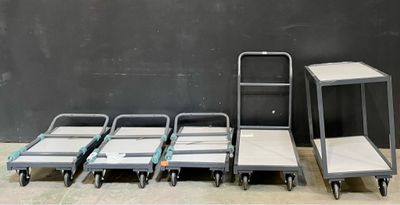 several carts are lined up next to each other in a room