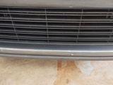 a close up of a car ' s grille with a cat on it
