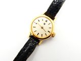 l'image d'une montre en or avec un bracelet en cuir noir