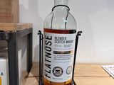 a bottle of whisky sitting on a shelf in a store