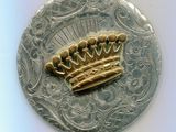 une pièce d'argent sur laquelle est représentée une couronne en or