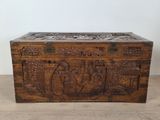 an old wooden chest with carvings on the sides
