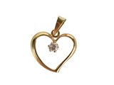 a gold heart shaped pendant with a diamond in the center
