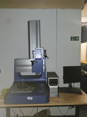 a blue machine sitting on a desk in a room