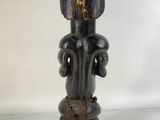 an image of a wooden statue of a man holding a dog