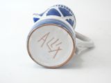 a blue and white vase with a fish design on it