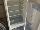 an open refrigerator that is sitting in the corner of a room