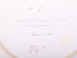 a white plate with writing on it sitting on a table