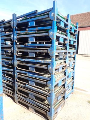 a stack of pallets sitting on top of each other in front of a building