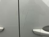 a close up of a door handle on a white car