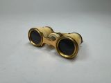 a pair of binoculars sitting on top of a white surface
