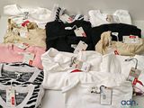 un grand nombre de t-shirts posés sur une table