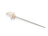 a close up of a metal stick with a flower on it