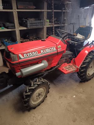 a red tractor that is parked in a garage