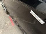 a sticker on the door of a car that is parked in a parking lot