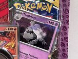 a box of pokemon cards with a picture of a cat on it