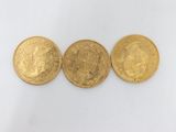 three gold sovereigns, one of which is a sovereign and one of which is a sovereign