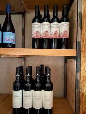 many bottles of wine sitting on a shelf in a room