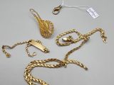two pairs of gold chains and a pair of earrings