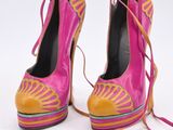 pair of pink and yellow high heeled shoes with laces on them
