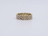 a yellow gold ring with diamonds on a white background