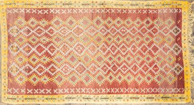 a red and yellow rug on a wooden floor