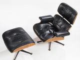 an image of a black leather chair and ottoman on a white surface