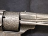 a gun that is sitting on a black surface