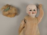 a doll and a doll head on the wall