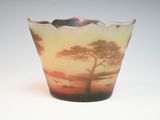 a glass vase with a picture of a tree on it