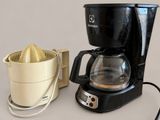 a coffee maker and a juicer sitting on a table