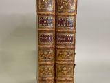 pair of antique leather bound books on a white background