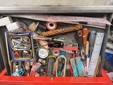 a red box filled with assorted items in it