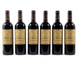 six bottles of wine are lined up on a white surface