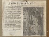 newspaper clipping with a picture of a woman in a dress and a man in a hat