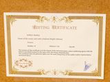 a certificate on a cork board with a picture of a bird