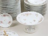 many plates and bowls that are sitting on a table