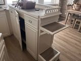 a kitchen with a sink and a counter with drawers