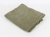 an image of a folded green blanket on a white background