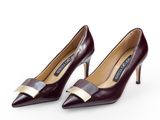 a pair of women ' s shoes with a bow on the heel