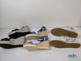 three pairs of women ' s shoes are lined up on a white surface