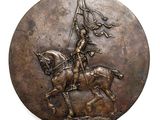 a bronze plaque of a man on a horse holding a flag