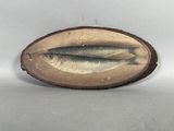 two fish that are sitting on a piece of wood