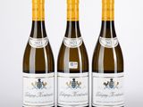 trois bouteilles de vin posées l'une à côté de l'autre sur une table