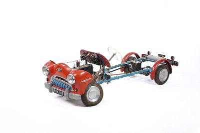 a toy car with a trailer attached to it on a white surface