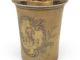 a gold cup with a horse on it on a white surface